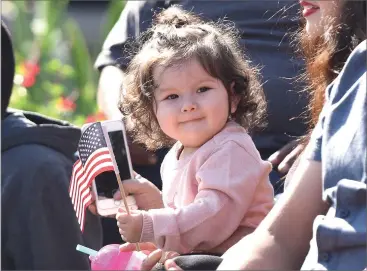  ?? RECORDER PHOTO BY CHIEKO HARA ?? A little spectator enjoys the parade Saturday during the 99th annual Veterans Day Parade in downtown Portervill­e.