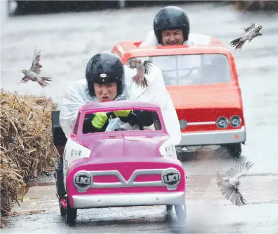  ??  ?? Ben Hannant (front) and Krisyian Paino nearly take out some birds as they hurtle down Burleigh Hill in their billy carts yesterday. Pictures: RICHARD GOSLING