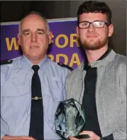  ??  ?? Ben D’Arcy, FDYS Gorey, is presented with his award by Inspector Pat Cody.