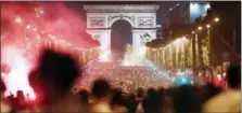  ?? JEAN-FRANCOIS BADIAS — THE ASSOCIATED PRESS ?? French fans celenbrate on the Champs Elysees, with the Arc de Triomphe in background, after France’s 1-0 win over Belgium.