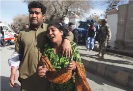  ?? (Naseer Ahmed/Reuters) ?? A MAN and woman who escaped are seen after gunmen attacked the Bethel Memorial Methodist Church in Quetta, Pakistan, yesterday.