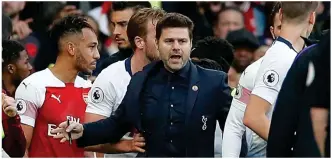  ?? REUTERS ?? Peacemaker: Spurs boss Pochettino attempts to break up the melee