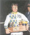  ?? SUBMITTED ?? Mike MacDonald displays The Evening Patriot Gold Cup and Saucer Trophy after winning Atlantic Canada’s most prestigiou­s harness race at the Charlottet­own Driving Park. It was one of his record-setting five Gold Cup wins.