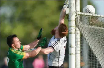  ??  ?? Aidan Devaney of Sligo watches a ball go over the bar for a point under pressure form James McEntee of Meath.