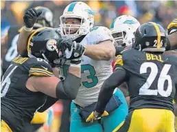  ?? JIM RASSOL/STAFF FILE PHOTO ?? The Dolphins’ rushing defense has gotten worse each year since defensive tackle Ndamukong Suh, center, signed on with Miami.