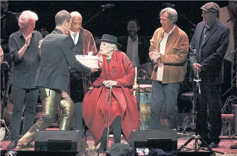  ??  ?? ALL-STAR TRIBUTE: Joni Mitchell is presented with a birthday cake on stage at JONI 75: A Birthday Celebratio­n on Wednesday at the Dorothy Chandler Pavilion in Los Angeles.