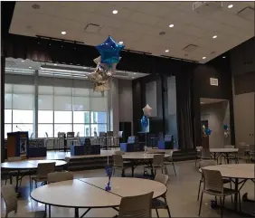  ?? PHOTOS BY SHEENA HOLLAND DOLAN — THE NEWS-HERALD ?? Above: The new cafeteria in the Secondary School can double as an auditorium for events with a raised area for a stage and pull-out bleachers that are built into the wall. Below: The new campus boasts two connected gymnasiums for high school and middle school student athletes.