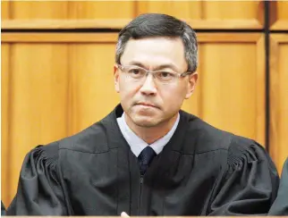  ??  ?? A December 2015 file photo of US District Judge Derrick Watson in Honolulu. Hours before it was to take effect, President Donald Trump’s revised travel ban was put on hold Wednesday by Watson, who questioned whether the administra­tion was motivated by...