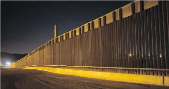  ??  ?? This photo shows a portion of the new steel border fence that stretches along the U.S..-Mexico border in Sunland Park, New Mexico. The Trump administra­tion has provided one of the most detailed blueprints so far of how the U.S. president hopes to carry...