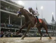  ?? AP PHOTO/MORRY GASH ?? Mike Smith rides Justify to victory during the 144th running of the Kentucky Derby horse race at Churchill Downs Saturday, May 5, 2018, in Louisville, Ky.