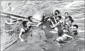  ?? Photo courtesy Library of Congress ?? North Vietnamese civilians capture John McCain (center) in Truc Bach Lake near Hanoi after his fighter jet was shot down Oct. 26, 1967. McCain broke both arms and a leg, then was bayoneted and beaten.