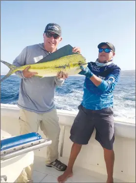  ?? Courtesy photo ?? The author and guide, Ruben Lopez, show a 31-pound dorado caught near Cabo, Mexico.