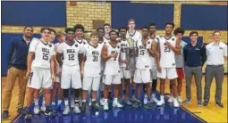  ?? AUSTIN HERTZOG - DIGITAL FIRST MEDIA ?? The Hill School boys basketball team celebrates with the champion’s trophy after defeating Taft School 60-45 in the final of the Mercer Invitation­al Tournament Sunday.