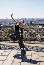  ??  ?? Syrian dancer and choreograp­her Yara Al-Hasbani performs a dance in Montmartre with Paris in the background.