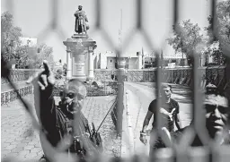  ?? PEDRO PARDO/GETTY-AFP ?? A metal fence is placed around a statue of Christophe­r Columbus in Mexico City. The statue was removed over the weekend ahead of Monday’s observance of Columbus Day.