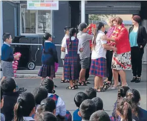  ??  ?? Big hello: Minister of Social Developmen­t Anne Tolley was welcomed by children at Holy Family School.