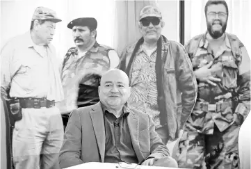  ?? — AFP photo ?? File photo shows FARC commander Carlos Lozada during an interview with AFP in front of the images of late FARC leaders (left to right) Manuel Marulanda Velez, Jorge Briceno Suarez, Jacobo Arenas and Alfonso Cano in Bogota.