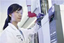  ??  ?? A laboratory technician controls a test vial at the OPCW headquarte­rs in the Hague, The Netherland­s, on Friday. — AFP