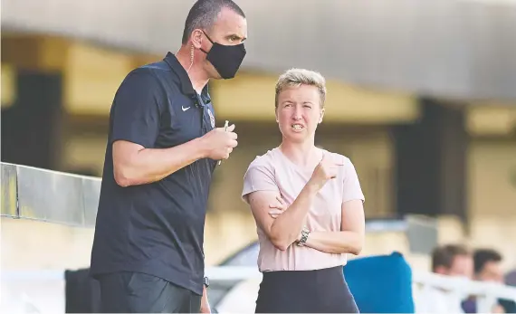  ?? GERARD FRANCO/CANADA SOCCER FILES ?? Bev Priestman, right, speaks to assistant Michael Norris during a game in Spain on June 11. Priestman says the team is capable of going for the gold.