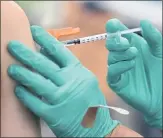  ?? RAY CHAVEZ STAFF ARCHIVES ?? A medical assistant administer­s a COVID-19 vaccine at a La Clinica testing and vaccinatio­n site on Fruitvale Avenue and East 12th Street in Oakland on June 15.