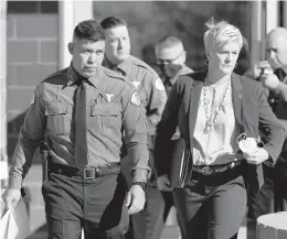  ?? ANDRES LEIGHTON/AP ?? Santa Fe County Sheriff Adan Mendoza and Santa Fe District Attorney Mary Carmack-Altwies make their way to a news conference Wednesday in New Mexico.