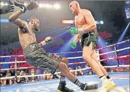  ?? REUTERS ?? ■
Tyson Fury (right) knocks down Deontay Wilder during the fight in Las Vegas on Saturday.