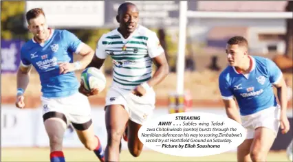  ?? Picture by Eliah Saushoma ?? STREAKING AWAY ... Sables wing Tafadzwa Chitokwind­o (centre) bursts through the Namibian defence on his way to scoring Zimbabwe’s secnd try at Hartsfield Ground on Saturday. —