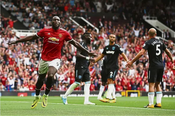  ?? — AP ?? Right on target: Manchester United’s Romelu Lukaku (left) celebrates after scoring the second goal against West Ham in the English Premier League match at Old Trafford yesterday.