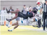  ?? VASHA HUNT/AP ?? Georgia State’s Bryquice Brown (5) tackles Ball State’s Jayshon Jackson during the first half of the Camellia Bowl on Saturday in Montgomery, Ala.