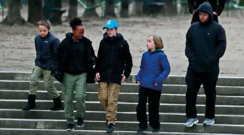  ??  ?? ABOVE LEFT: Knox, Zahara, Shiloh and Vivienne with a bodyguard out and about in Paris. The Jolie-Pitt kids’ style is far less flashy than other A-lister kids’. ABOVE RIGHT: Playing in the Tuileries Garden.