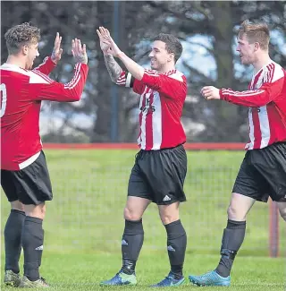  ??  ?? Dundee Argyle captain Kevin Egan (centre) celebrates his goal with teammates in the 4-0 Chairman’s Cup Final triumph over Tayport at The Canniepart.
