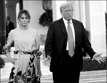  ?? LYNNE SLADKY / ASSOCIATED PRESS ?? Former President Donald Trump, right, stands with Melania Trump as they arrive for a GOP fundraiser Saturday in Palm Beach, Fla.