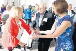  ?? PHOTOS BY STEPHEN M. DOWELL/STAFF PHOTOGRAPH­ER ?? Holocaust survivor Tess Wise, left, is greeted by Pam Kancher, right, during a ceremony at the Dr. Phillips Center for Performing Arts to unveil plans for a new Holocaust center.