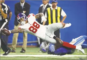  ?? Gregory Shamus / Getty Images ?? The Giants’ Evan Engram dives for a first down while being tackled by the Lions’ Tavon Wilson during a preseason game on Friday.