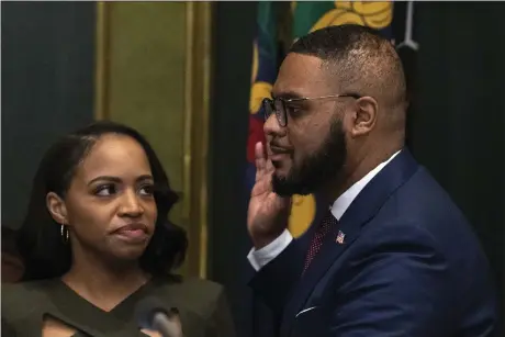  ?? MATT ROURKE - THE ASSOCIATED PRESS ?? Austin Davis accompanie­d by his wife, Blayre Holmes Davis, takes the oath of office to become Pennsylvan­ia’s first Black lieutenant governor during a ceremony Jan. 17 in Harrisburg.