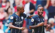  ?? Reuters ?? Manchester City’s Raheem Sterling celebrates with Fernandinh­o after scoring City’s first goal against Arsenal at Emirates Stadium, London, yesterday.