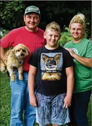  ?? JOSHUA A. BICKEL PHOTOS / THE COLUMBUS DISPATCH ?? Mike and Teresa Cuckler and their son Layton, 11, take a portrait in Piketon. Their small farm is near the south gate of the former Portsmouth Gaseous Diffusion Plant.