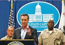  ?? RICH PEDRONCELL­I/ASSOCIATED PRESS ?? California Gov. Gavin Newsom discusses his decision to withdraw several hundred National Guard troops from the nation’s southern border and change their mission during a Capitol news conference Monday in Sacramento. Newsom is flanked by Maj. Gen. David Baldwin, the adjutant general of the California Military Department, left, and California Highway Patrol Commission­er Warren Stanley.