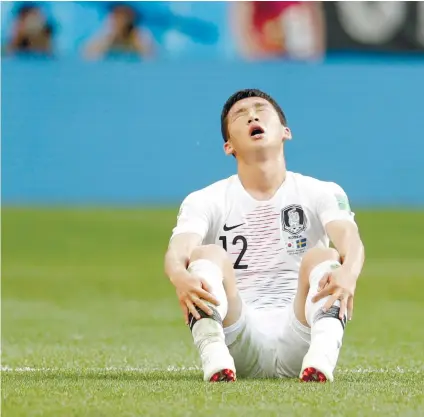  ?? AP FOTO ?? PAINFULSou­th Korea’s Kim Min-woo sits on the pitch at the end of the group F match between Sweden and South Korea at the 2018 World Cup in Russia. Sweden won 1-0 via penalty kick.