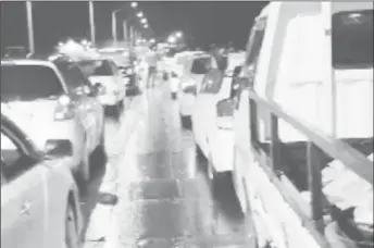  ?? ?? The situation on the Demerara Harbour bridge on Friday night as a result of the traffic build up