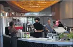  ?? ALEX WELSH THE NEW YORK TIMES ?? Staff at Dinosaur Coffee on Sunset Boulevard in Los Angeles wear masks while interactin­g with customers on Tuesday, as coronaviru­s cases keep climbing.