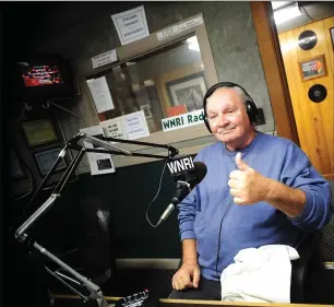  ?? Photo by Ernest A. Brown ?? Woonsocket’s ‘Country’ Bob Braden gives a thumbs up while doing his country music program at the WNRI studios in
the city last Thursday. Although Braden is afflicted with a rare genetic disorder that affects
his sight, hearing and speech, he hasn’t...