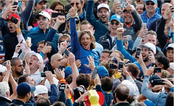  ?? REUTERS ?? Mosh pit: Tommy Fleetwood, the golfer with the rock star looks, enjoys Ryder Cup victory with the fans in Paris