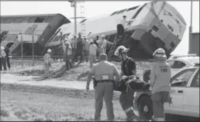  ?? AP photo ?? Emergency personnel respond to the scene of a train derailment in California’s Central Valley Monday.