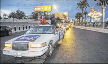  ?? L.E. Baskow Las Vegas Review-Journal @Left_Eye_Images ?? People celebrate President-elect Joe Biden’s victory over President Donald Trump with a car parade Saturday on the Strip. At right, attendees pass by the “Welcome to Fabulous Las Vegas” sign. The event was organized by Mi Familia Vota and featured members of the local Biden-Harris campaign.