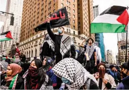  ?? (AP) ?? BIG APPLE RALLY — Pro-palestinia­n demonstrat­ors chant during a protest on Friday, April 12, 2024, in New York City.