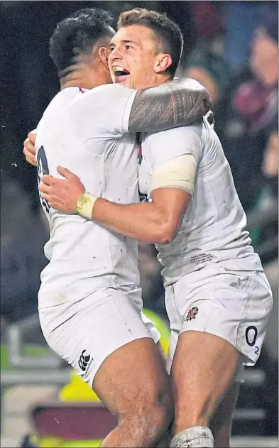  ??  ?? Henry Slade celebrates with Manu Tuilagi of England after scoring their side’s third try
