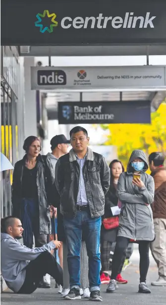  ?? Picture: AFP ?? SWELLING RANKS: People queue up outside a Centrelink office in Melbourne.