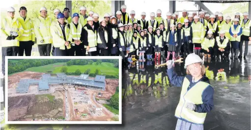  ??  ?? Xanthe Watkin (front) with other guests at the King’s developmen­t topping out ceremony and (inset) an aerial view of the work in progress