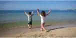  ??  ?? Two children play on the Portixol Beach in Palma de Mallorca.